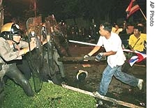Anti-coup government demonstrators attack Bangkok police Sunday, July 22, 2007, during a demonstration